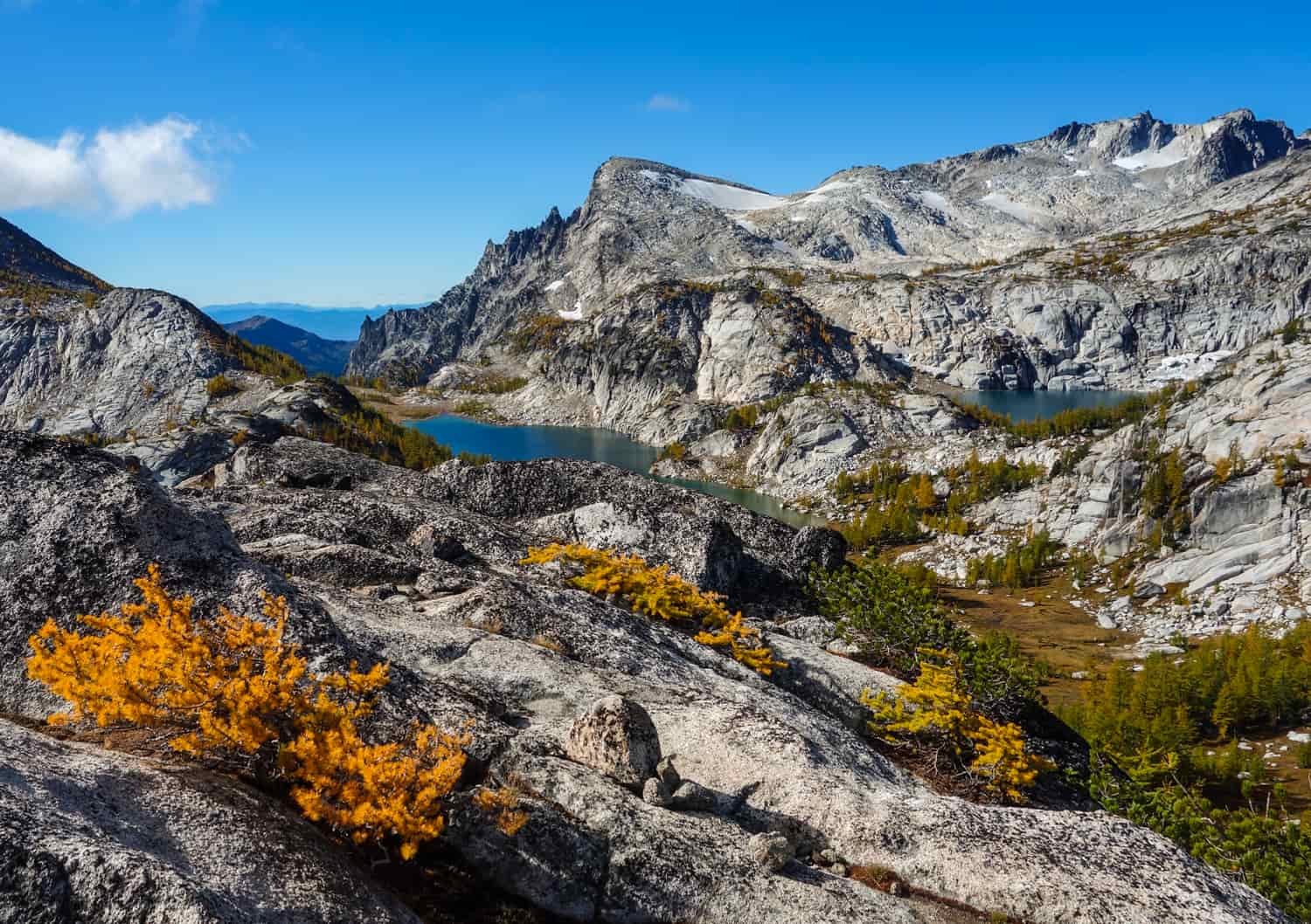 alpine lake with larch and bushes in the enchantment lakes wilderness