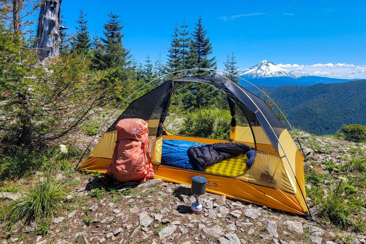 The REI Half Trailmade 2 backpacking tent set up on a ridge with a view of Mt. Hood in the background