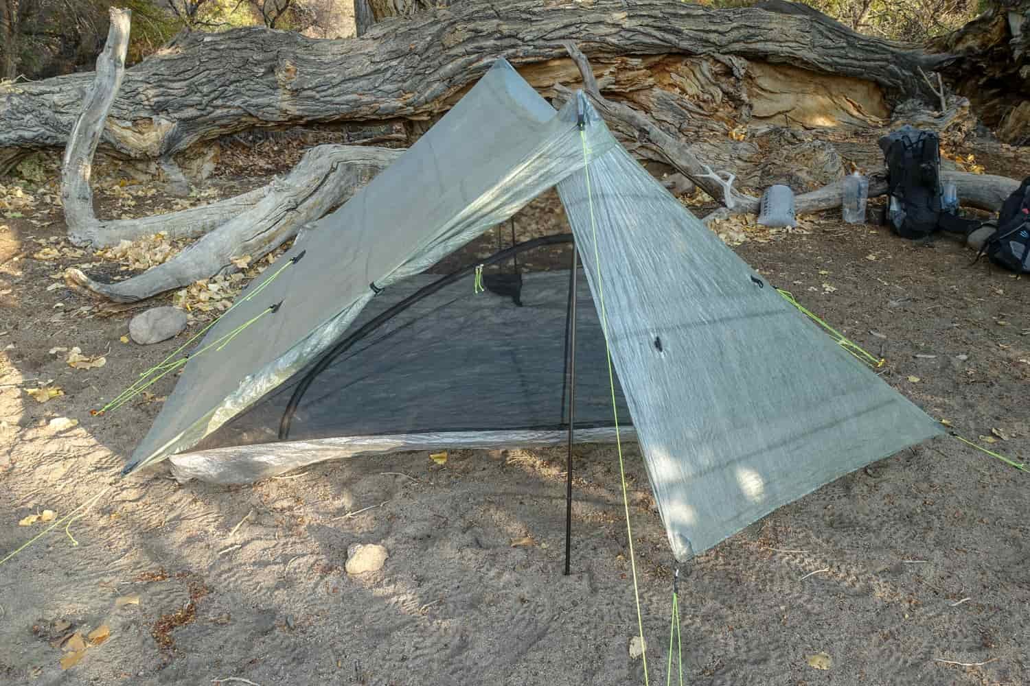 storm door rolled back and the zpacks triplex classic set up in camp