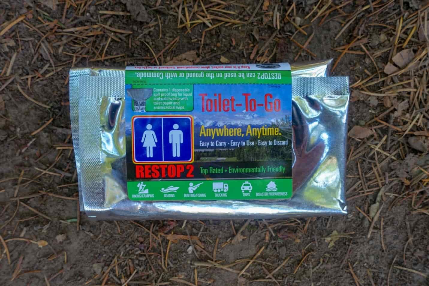 a wag bag unopened in the woods on the ground