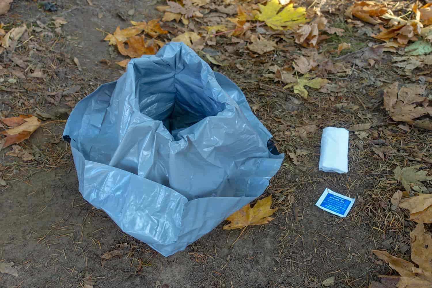 a bucket with a trash bag for going to the bathroom in. 