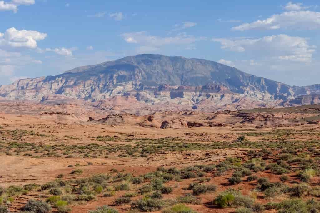 Scenic landscape view of red, tan, and green desert mountains