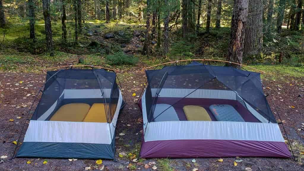 The smaller REI Half Dome 2 Plus tent on the left next to the larger REI Half Dome 4 Plus tent on the right