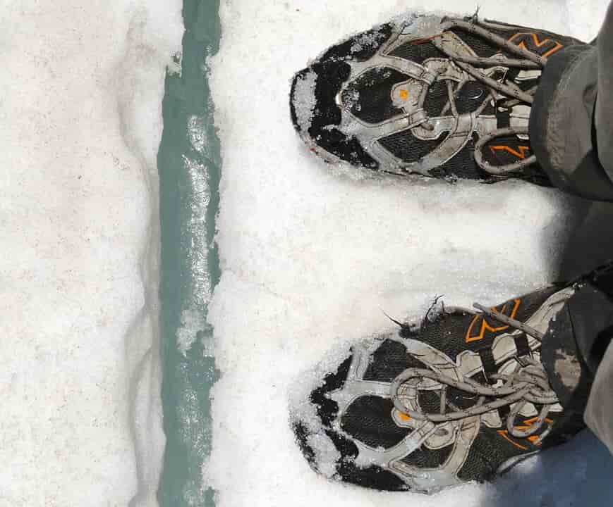 two black boots poke into frame against a snowy backdrop