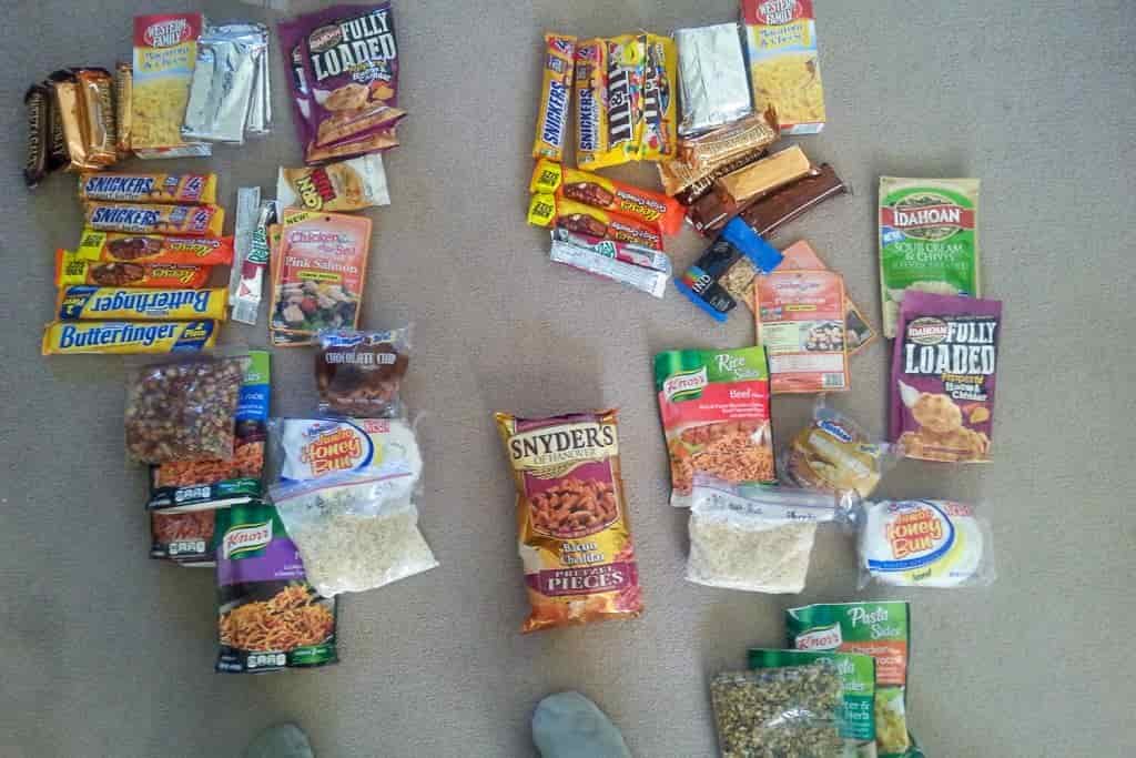 Backpacking food, snacks, and candy bars spread out on the floor