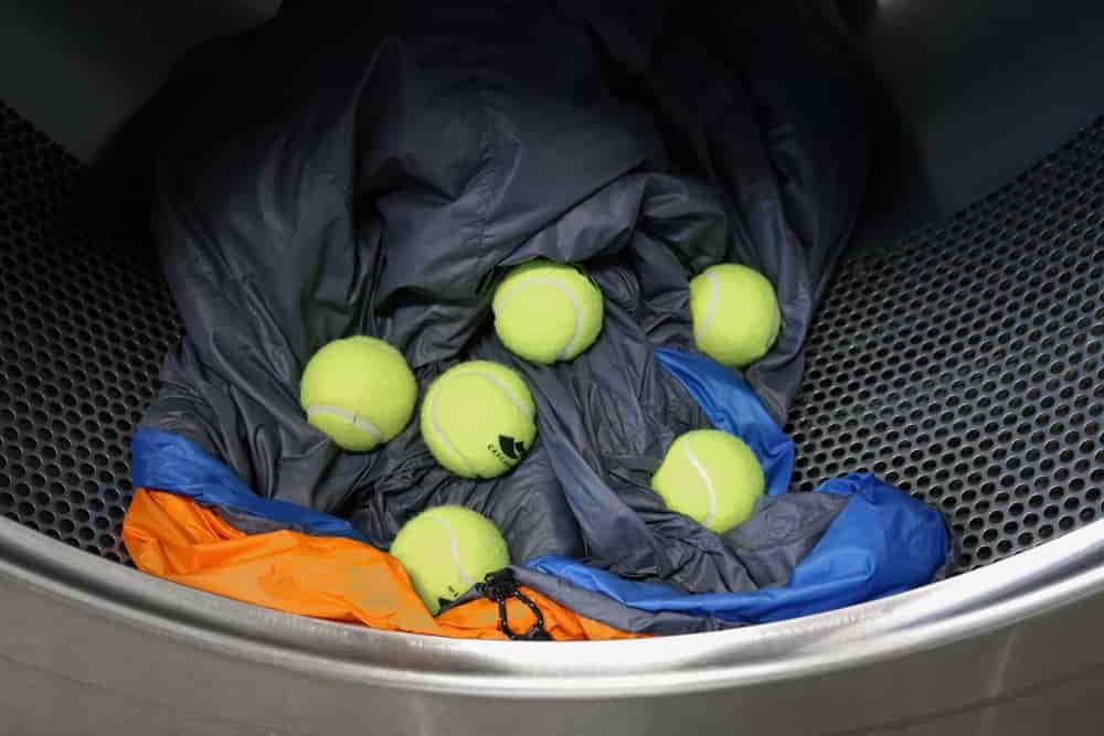 6 tennis balls in a dryer with a down sleeping bag 