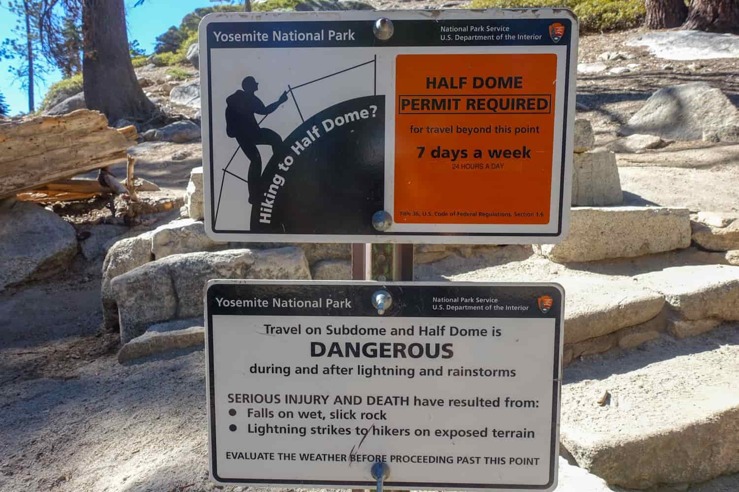 sign warning the dangers of falling or lightning strikes while hiking half dome.