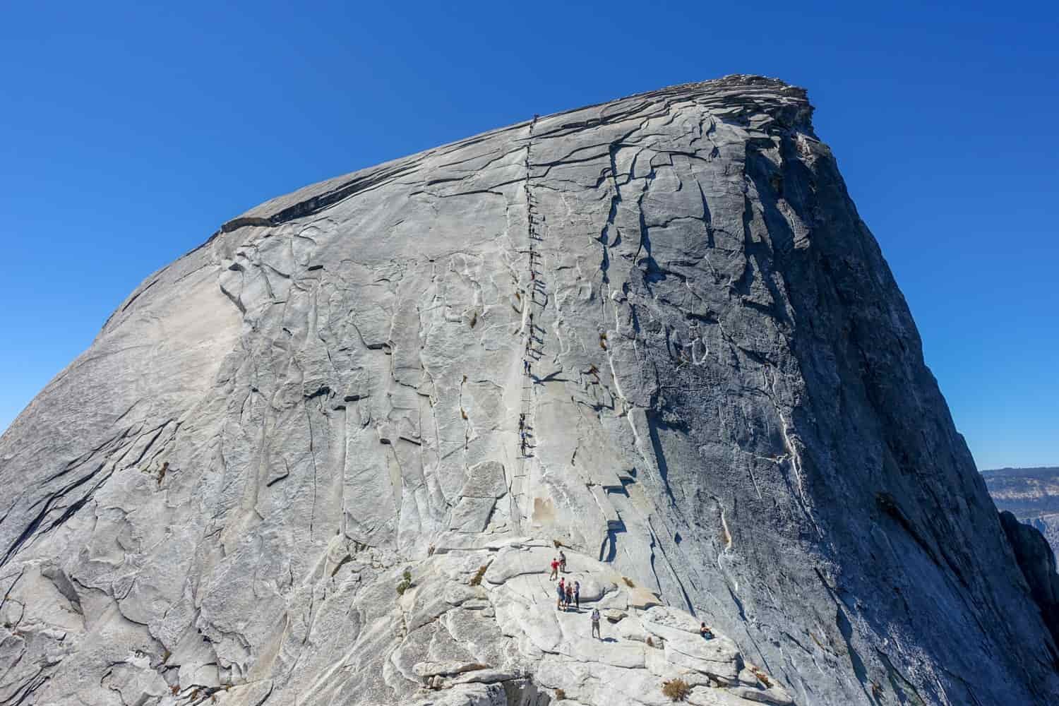 hikers using the cables on half dome to the summit
