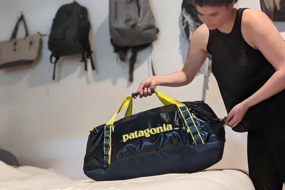 person holding a duffel in a room