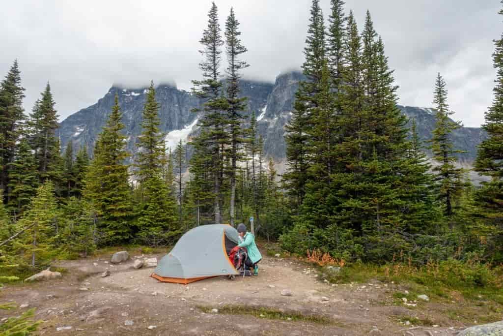 backpacker with tent set up