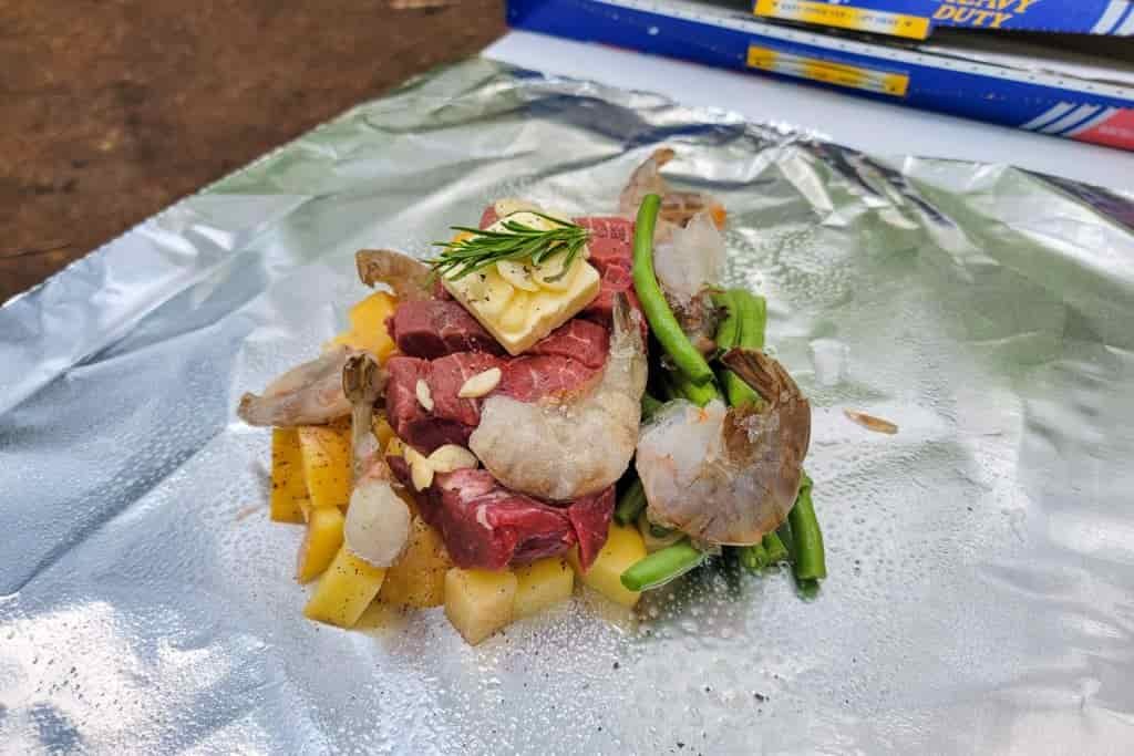 uncooked ingredients in a foil pack to be cooked