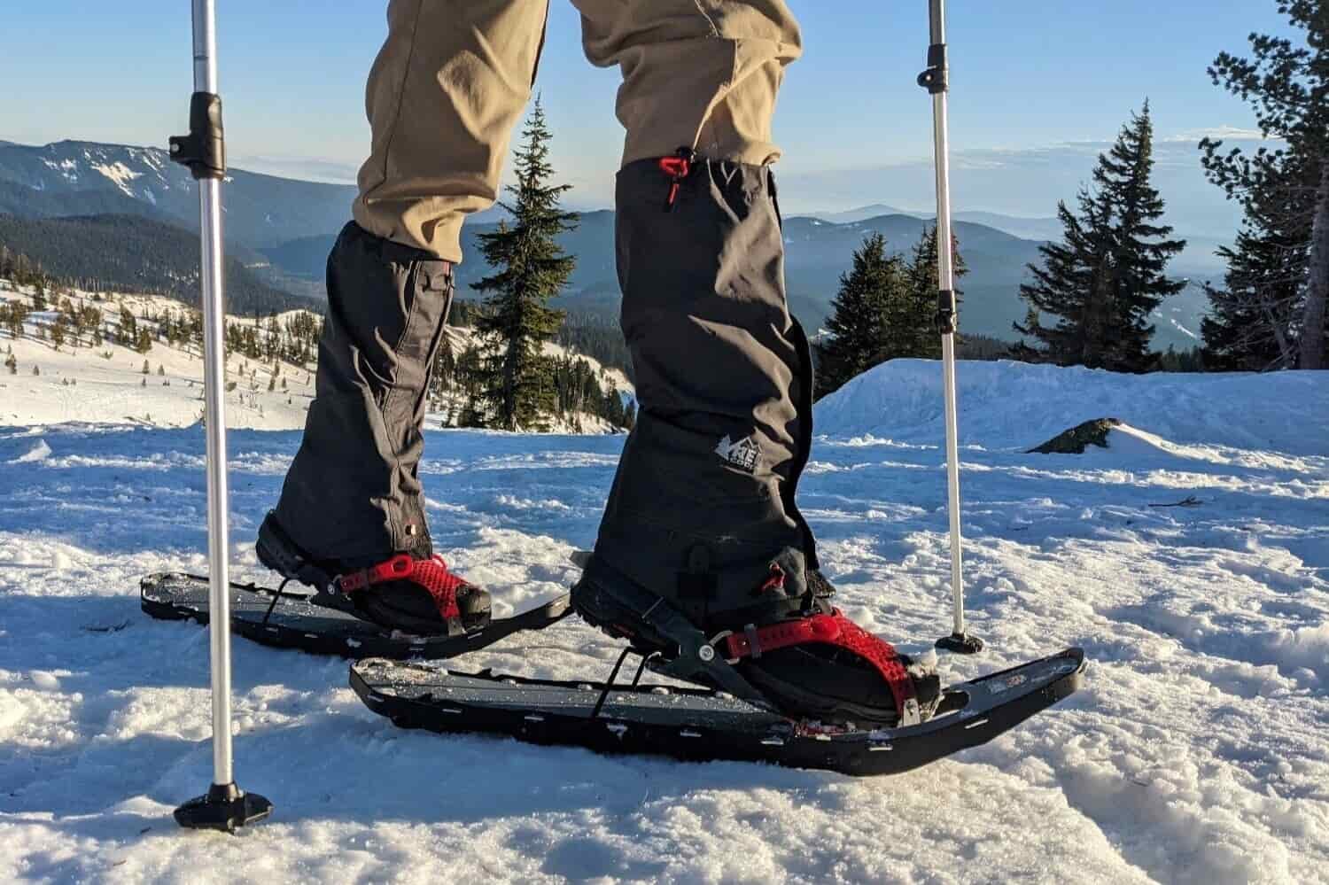 the legs of a hiker wearing the msr lightning ascent snowshoes
