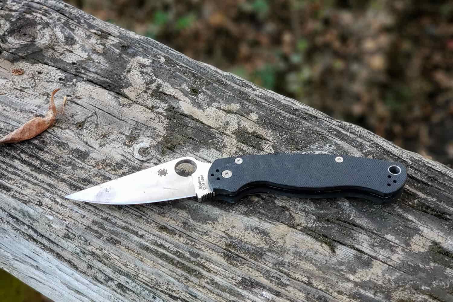 a spyderco knife open on a wooden board