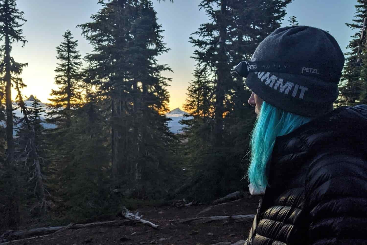 Profile-view-of-a-woman-wearing-the-Petzl-Actik-headlamp-at-dusk
