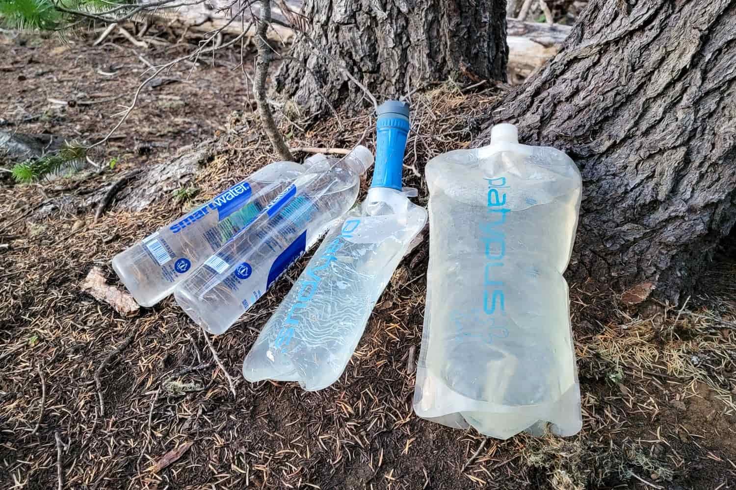 bladders, reservoirs, waterbottles with a platypus quickdraw on the ground