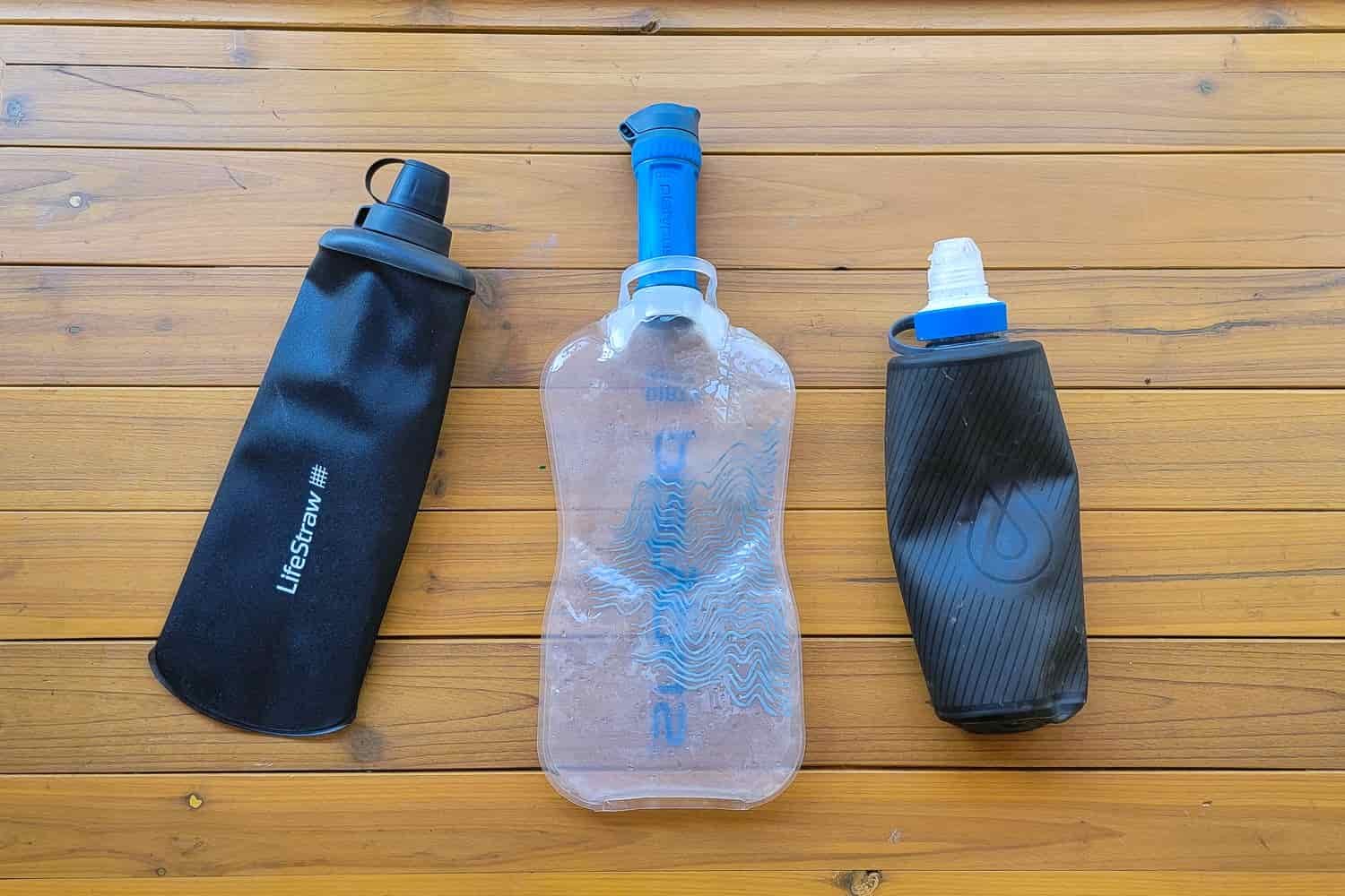 Left to right: LifeStraw Peak Squeeze, Platypus QuickDraw; Katadyn BeFree with the Hydrapak Flux Bottle on a table