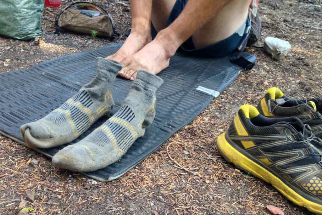 A thru hiker's socks standing up on their own