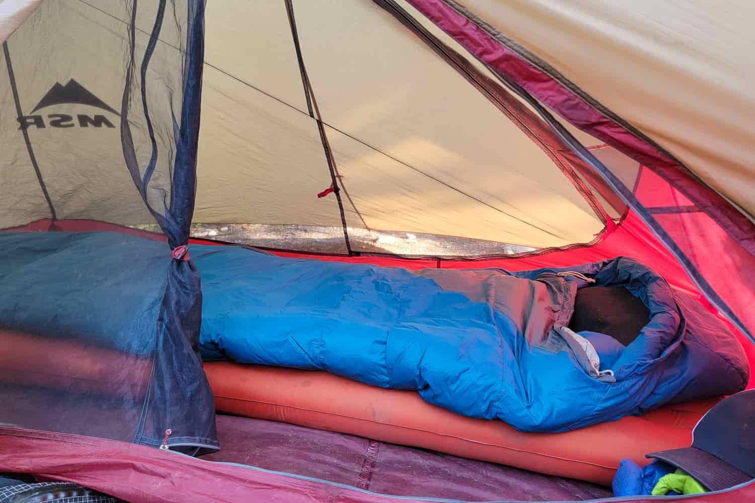 The MSR FreeLite tent with a sleeping bag and pad set up