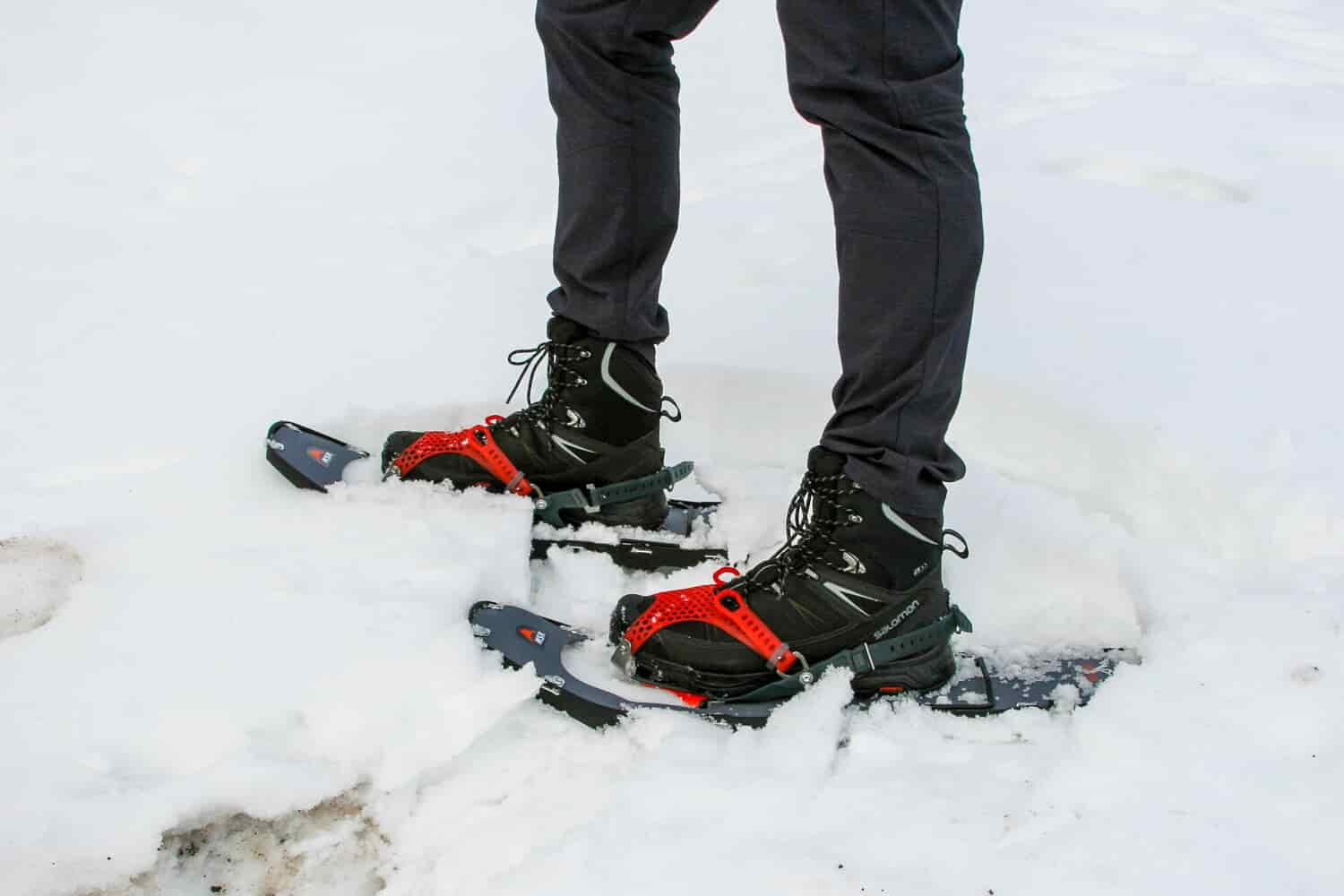 image of a hiker wearing snowshoes on snow.
