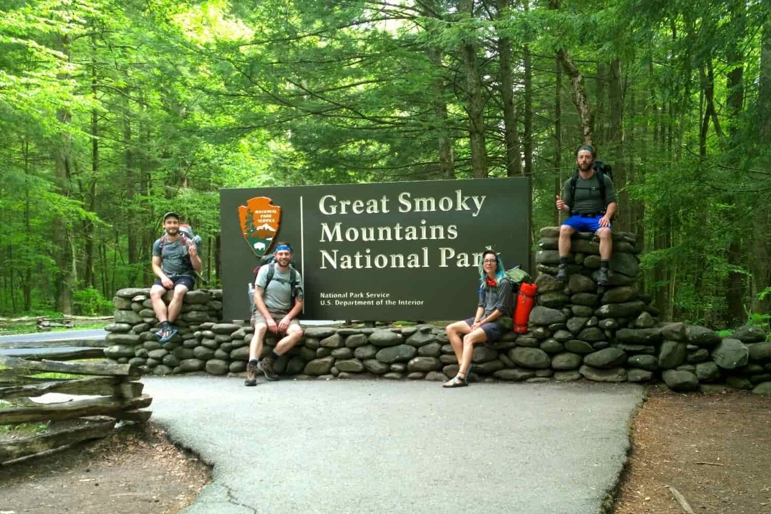 Thru-hikers pose in front of Great Smokey Mountains National Park entrance sign