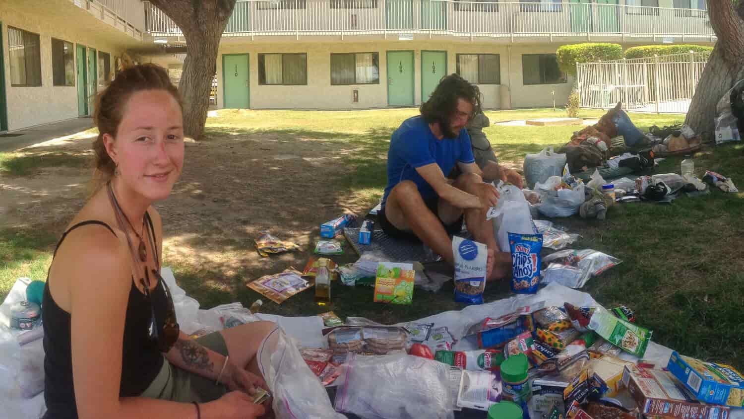 thru-hikers at a hotel repacking their food supplies for the next leg of their hike.