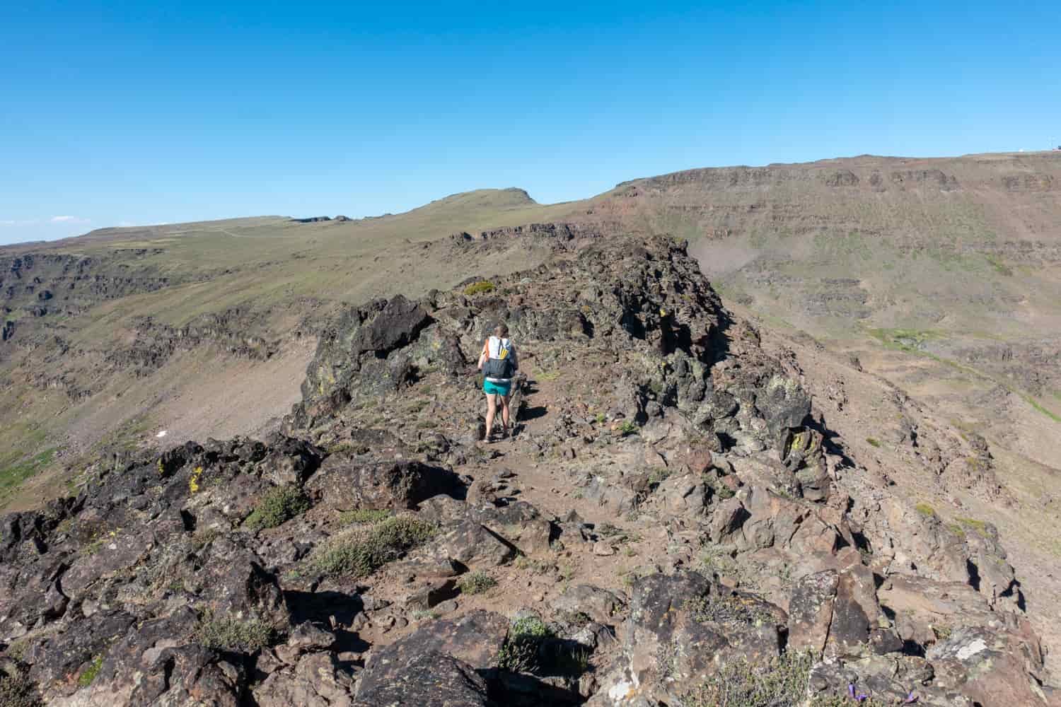 backpacker scrambling in the steens in southeastern oregon