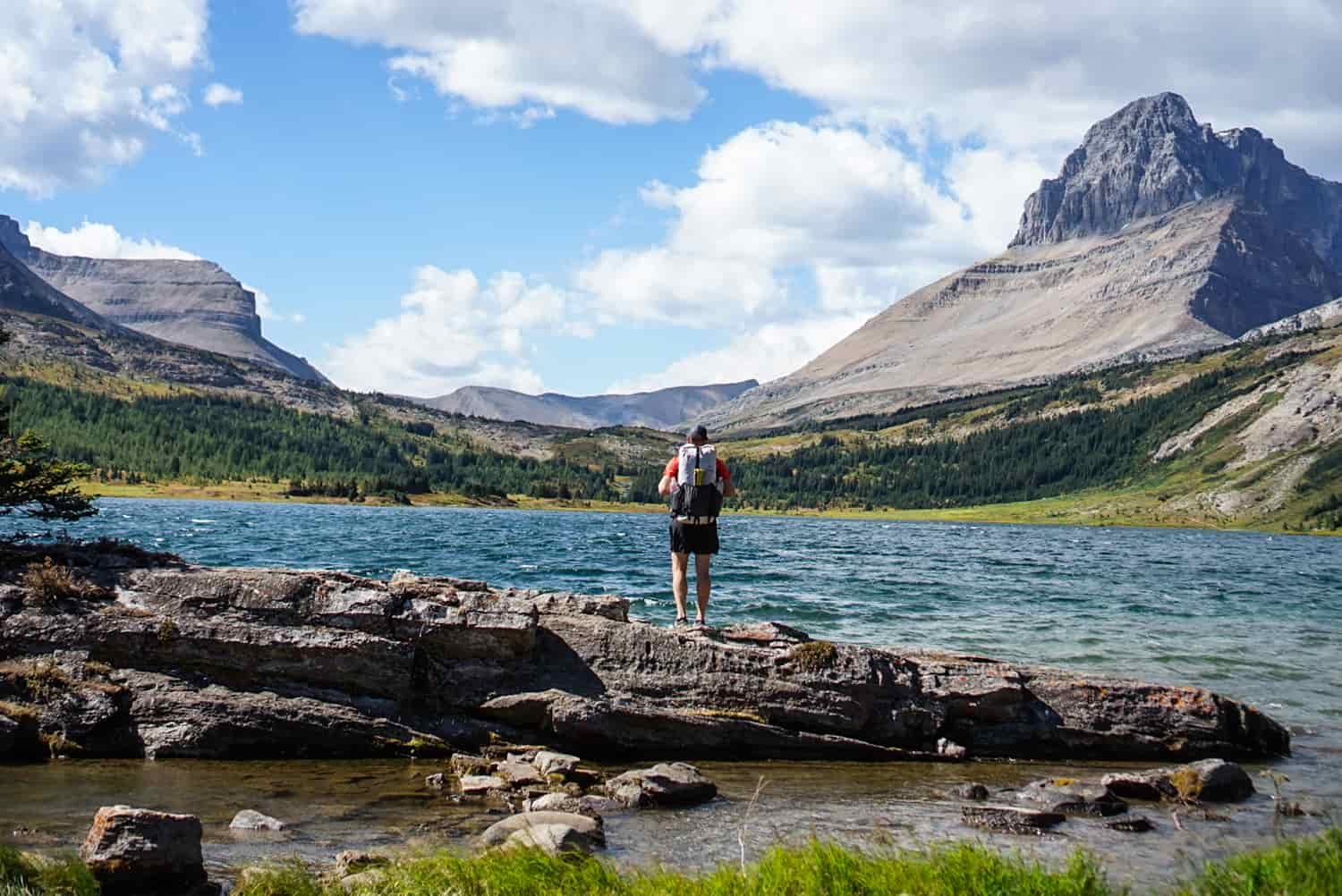 backpacker looks over a lake on the sawback trail in banff