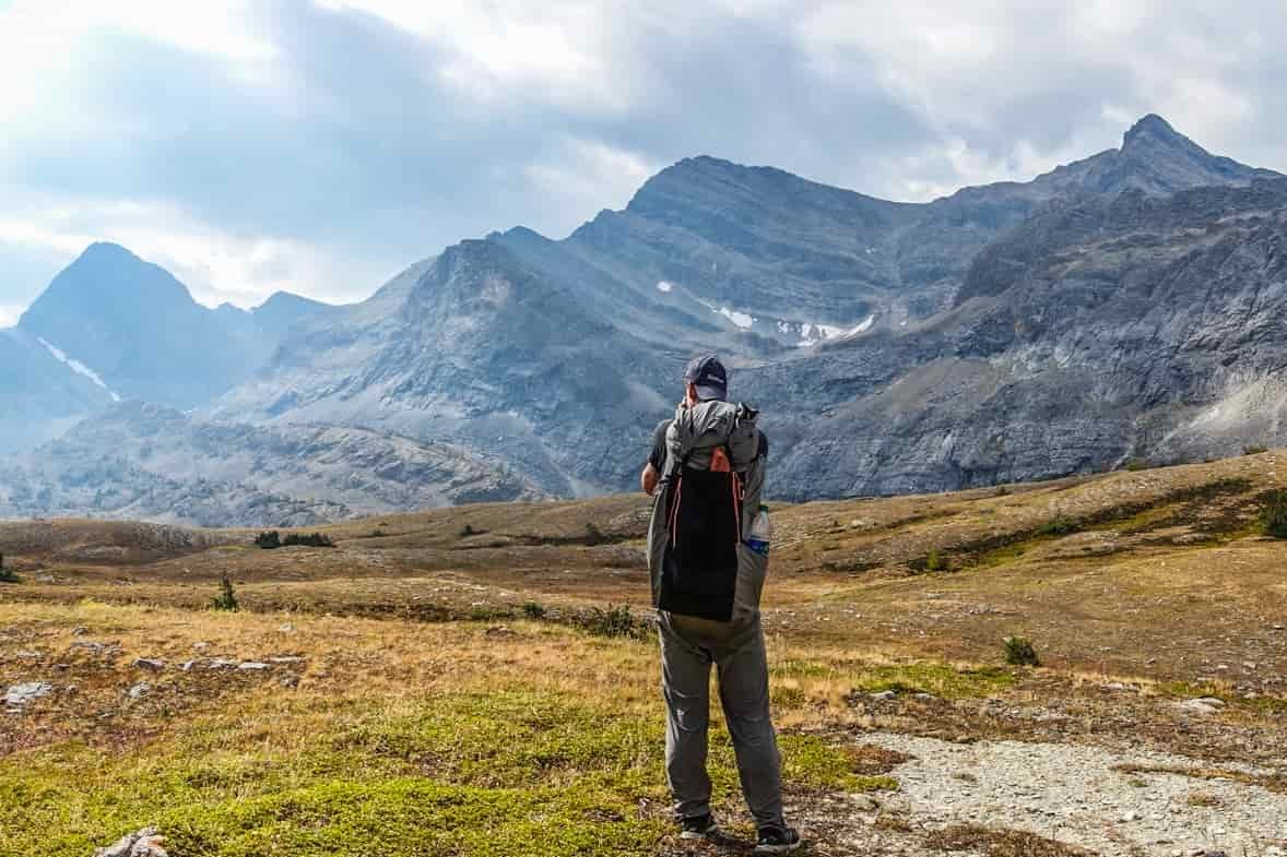 backpacker taking a picture of the candian rocky mountains in banff