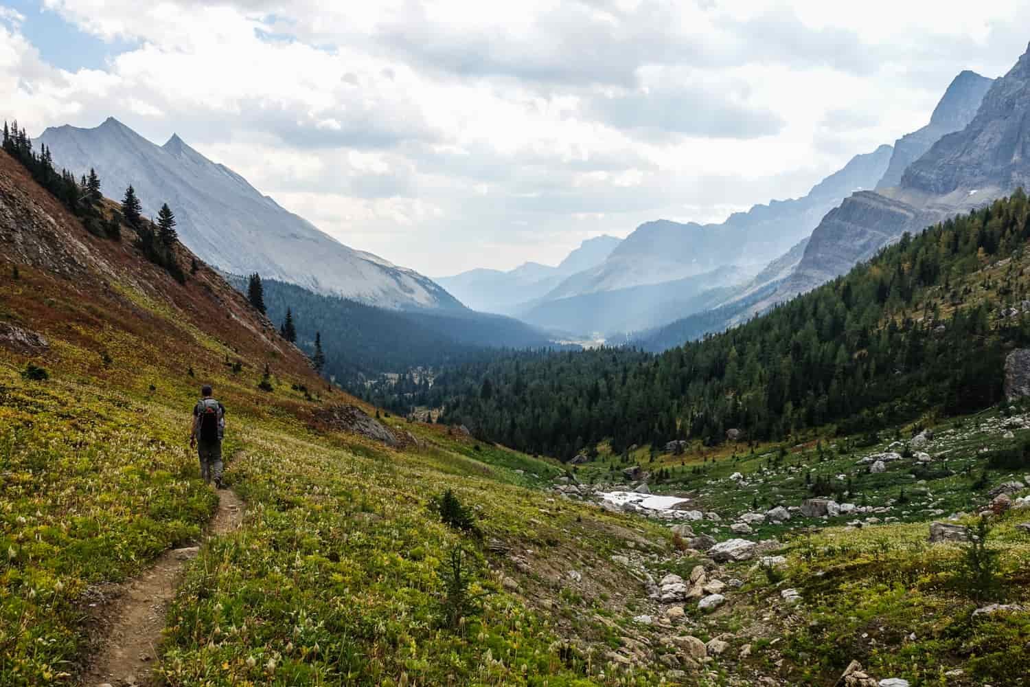 backpacker on a trail in a glaciated valley in banff national park