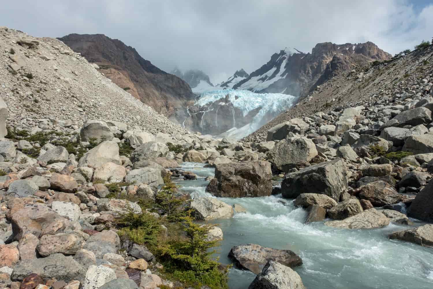 Landscape picture with a snow-melt stream flowing down from a glacier in the Patagonian mountains