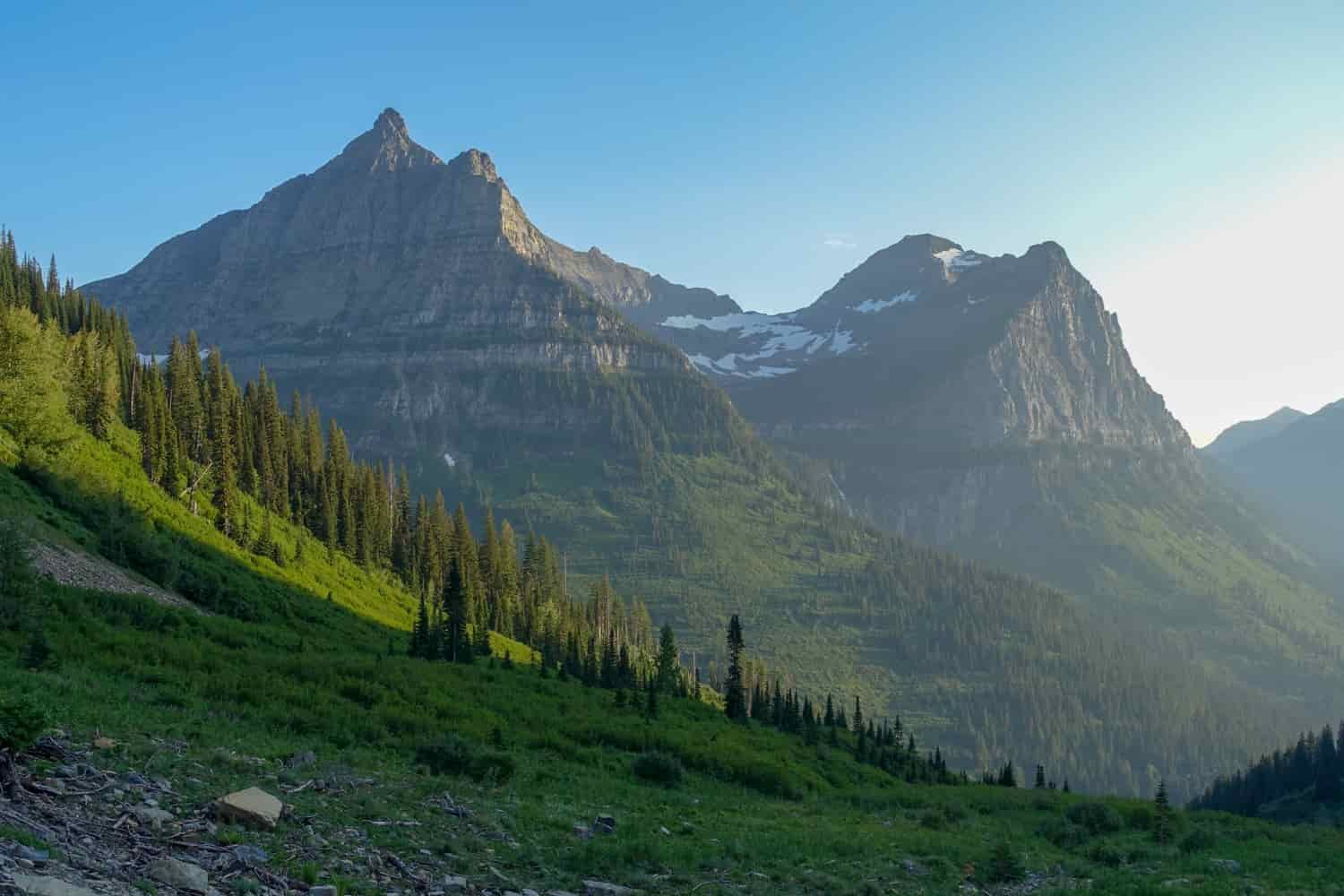 green slopes and peaks in glacier national park on a sunny day