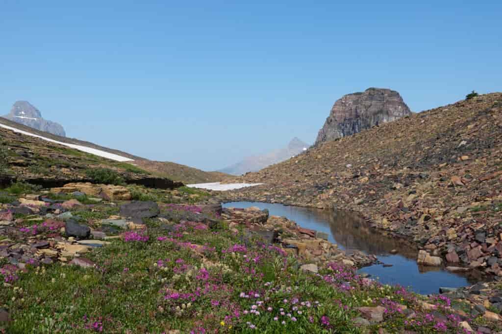 blue skies with some low cloud mist on a pass in glacier national park