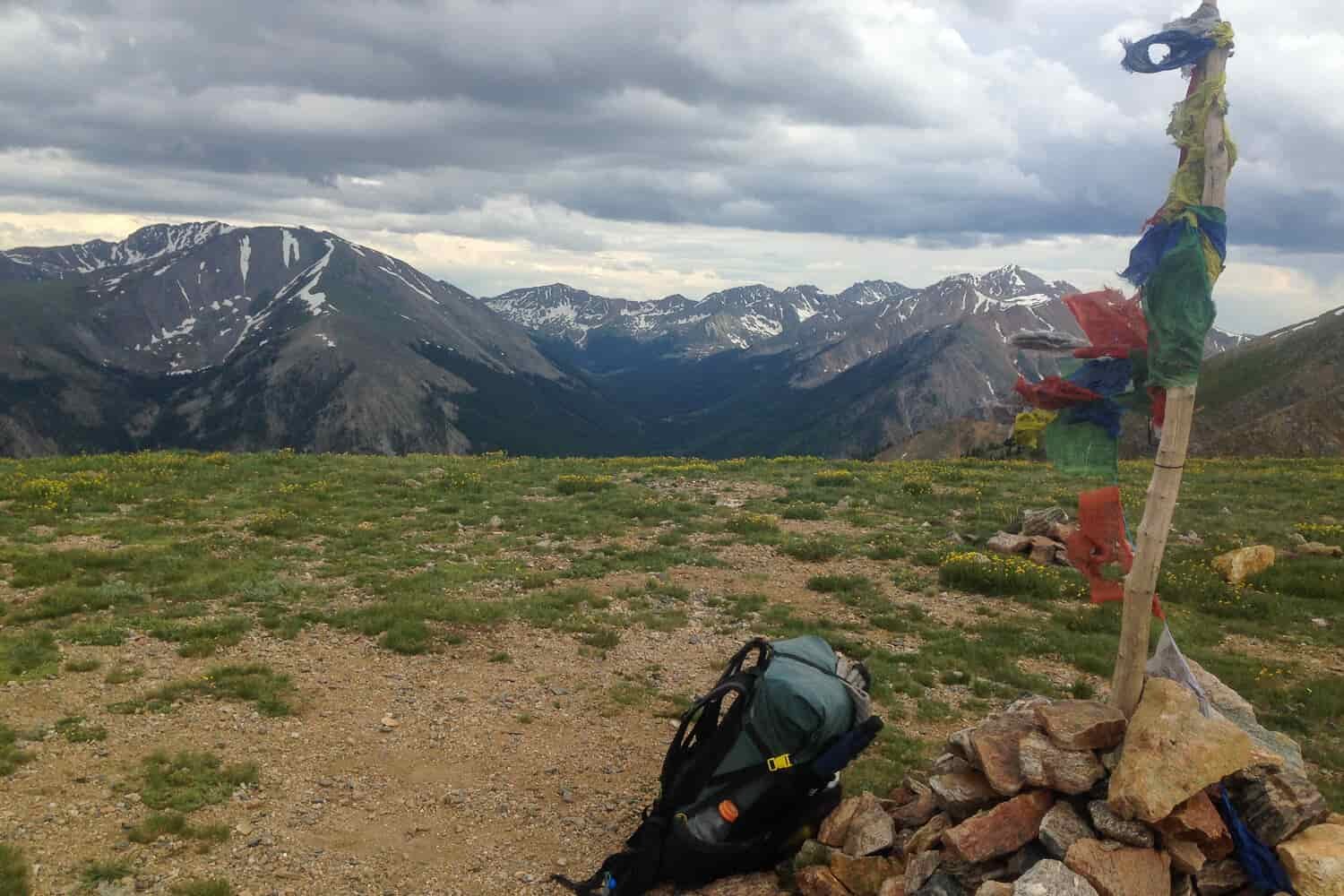 rock cairn and prayer flags mark the trail on the CDT