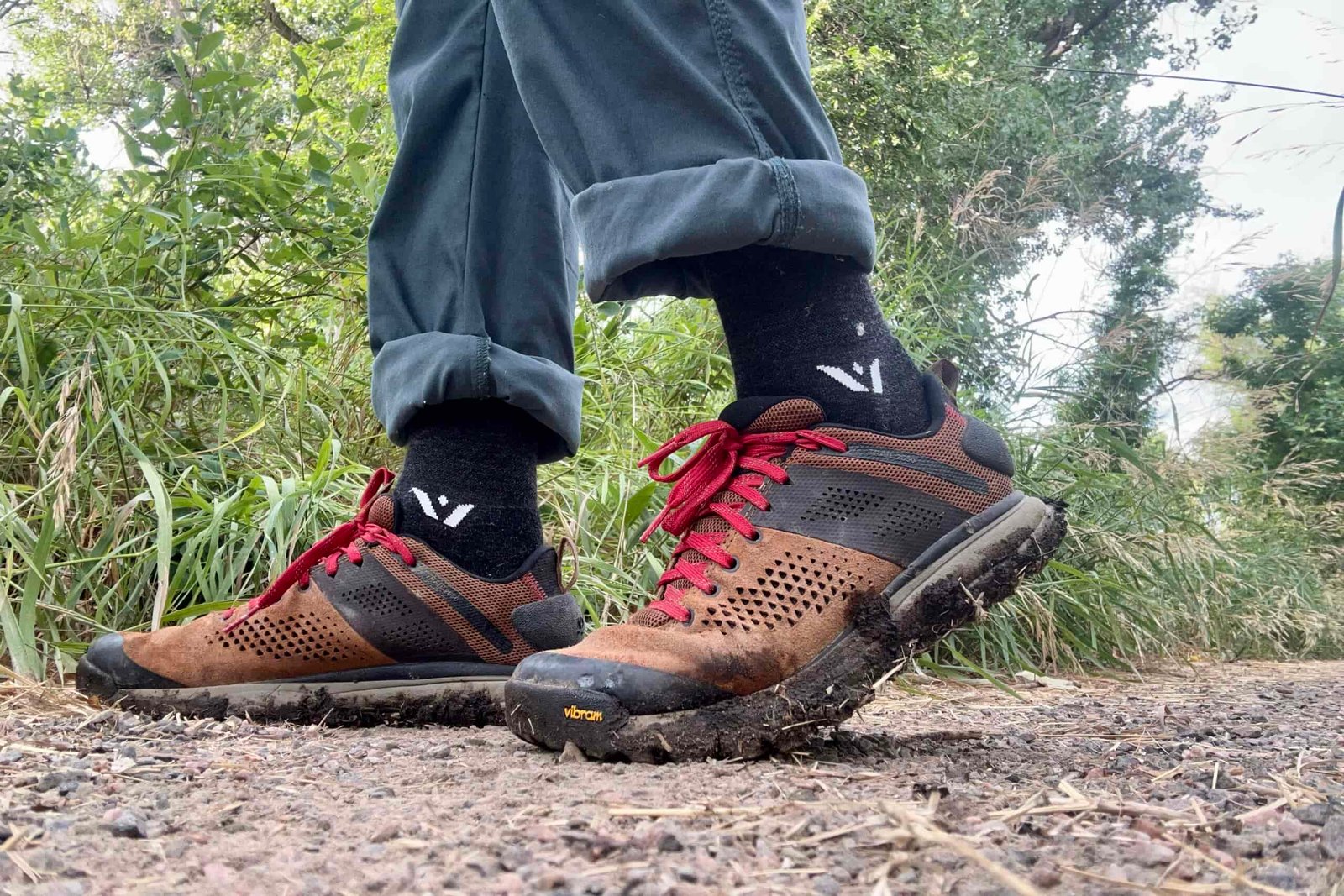 Close-up shot from the knees down of a man wearing the Danner Trail 2650 hiking shoes.