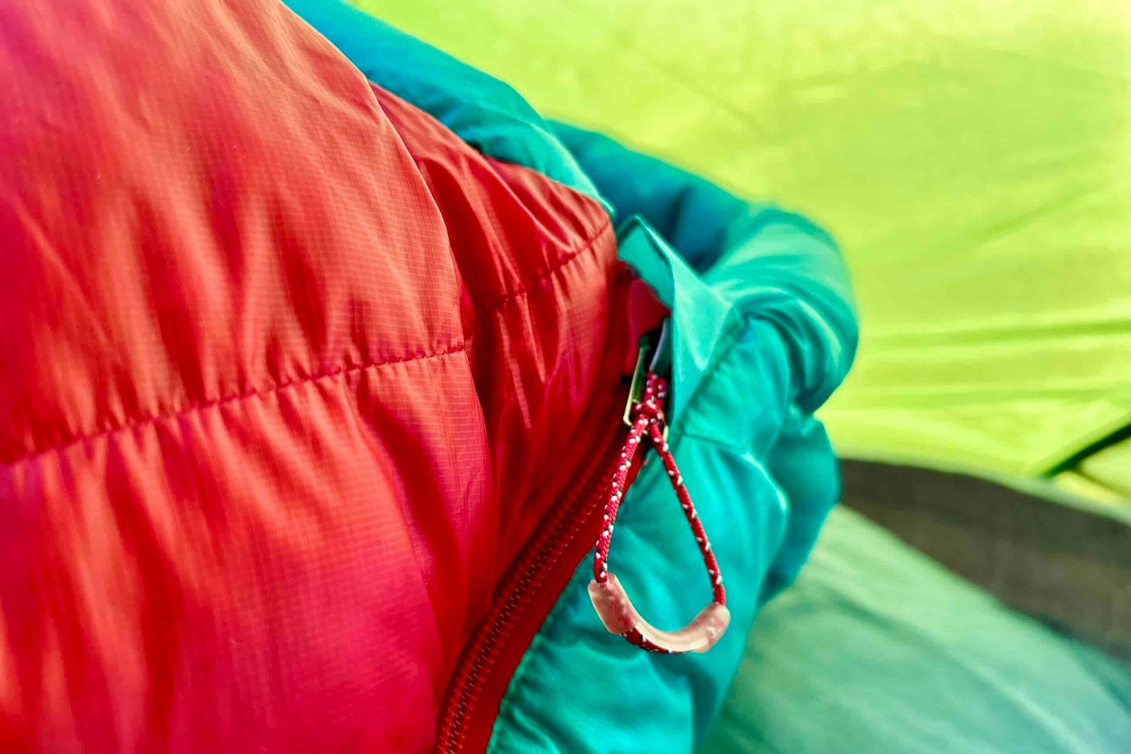 An up-close image of a zipper pull on a sleeping bag.