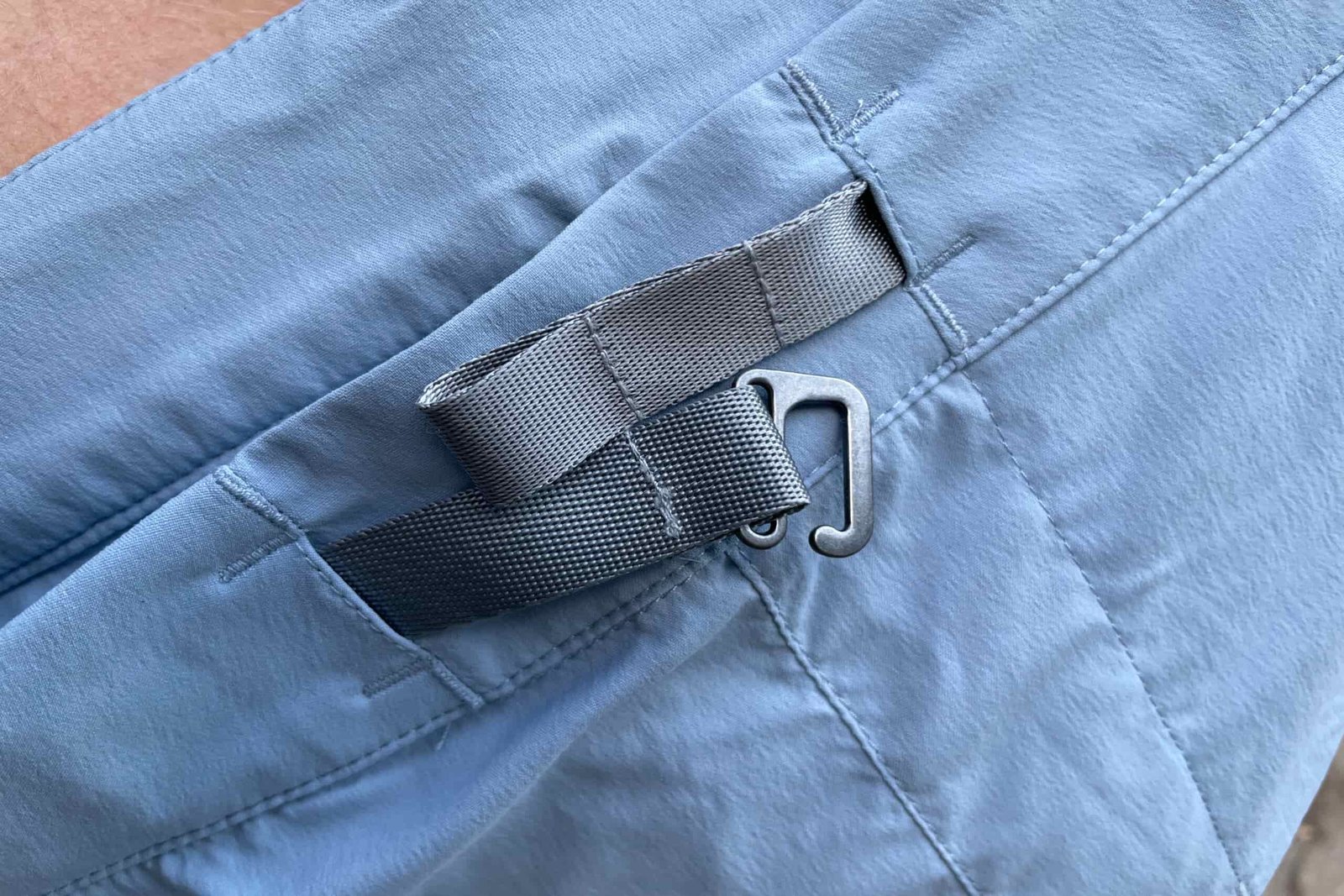 a closeup of the buckle and material on the houdini wadi shorts