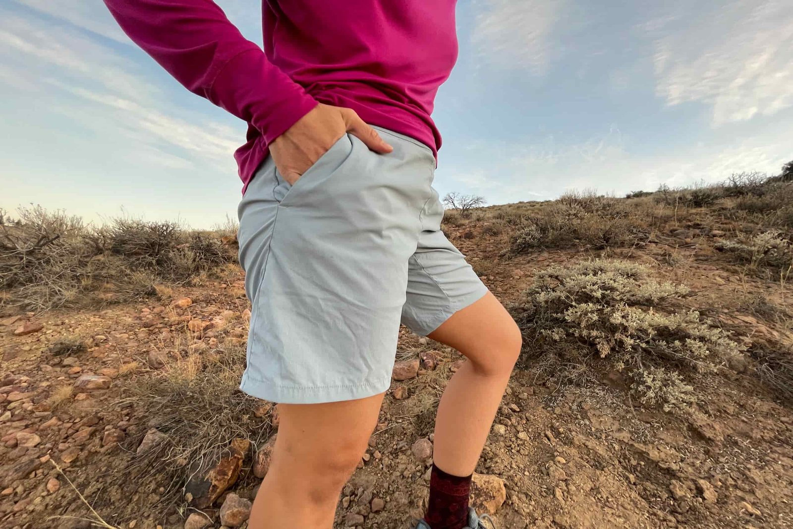 a close up of the houdini wadi shorts in light blue on a gear analyst in a rocky environment