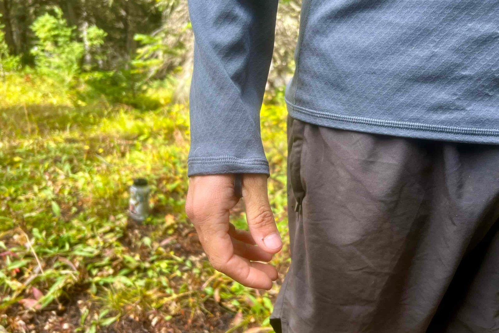 A close up of the wrists on the Patagonia Capilene. Trees are in the background.