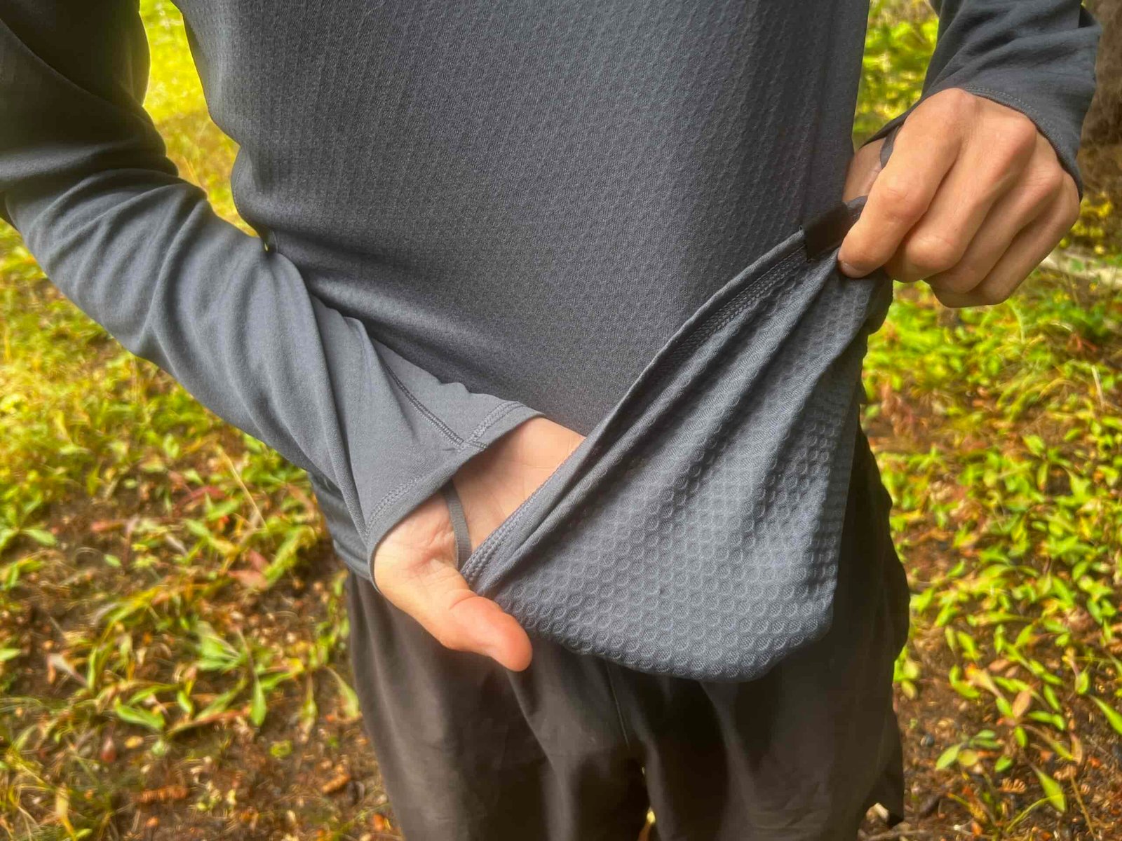 A hiker showing the waffled texture of the Patagonia Capilene.