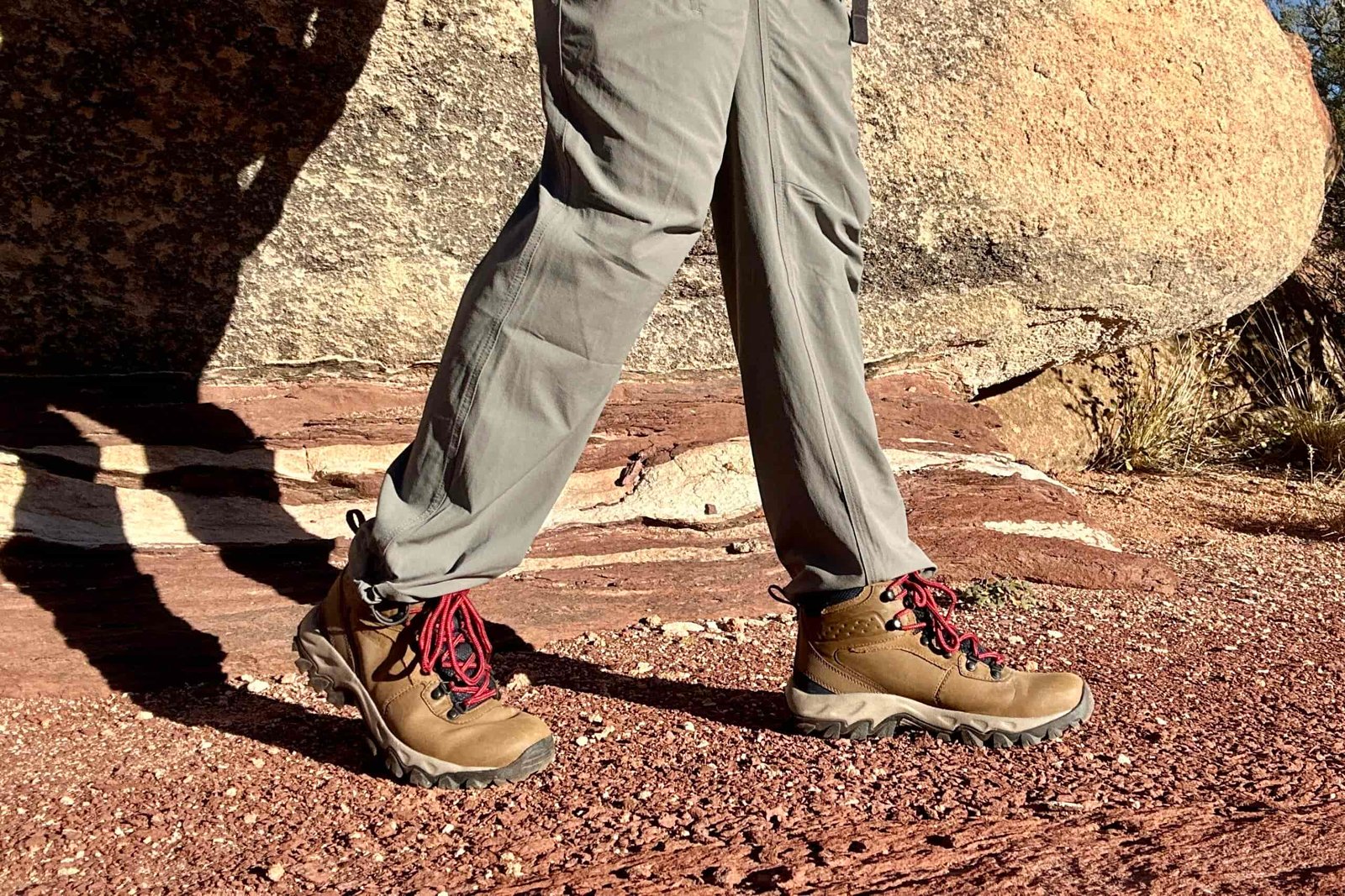 Close up of a man walking in hiking boots, image from knees down.