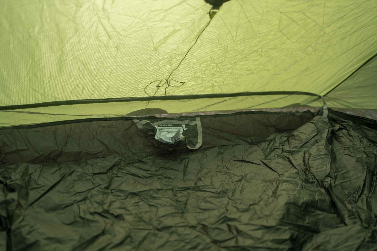 a view inside a green tent looking at a pocket