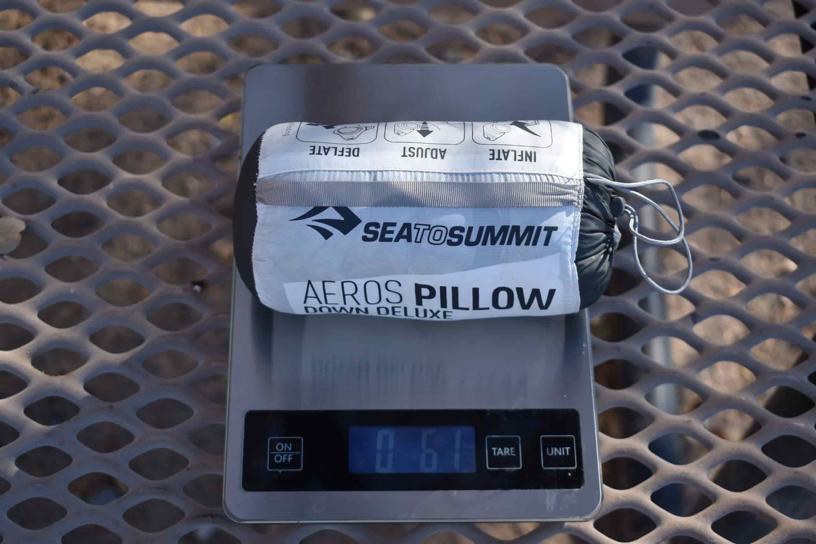 The Sea to Summit Down Deluxe sits on a kitchen scale that reads 6.1 oz