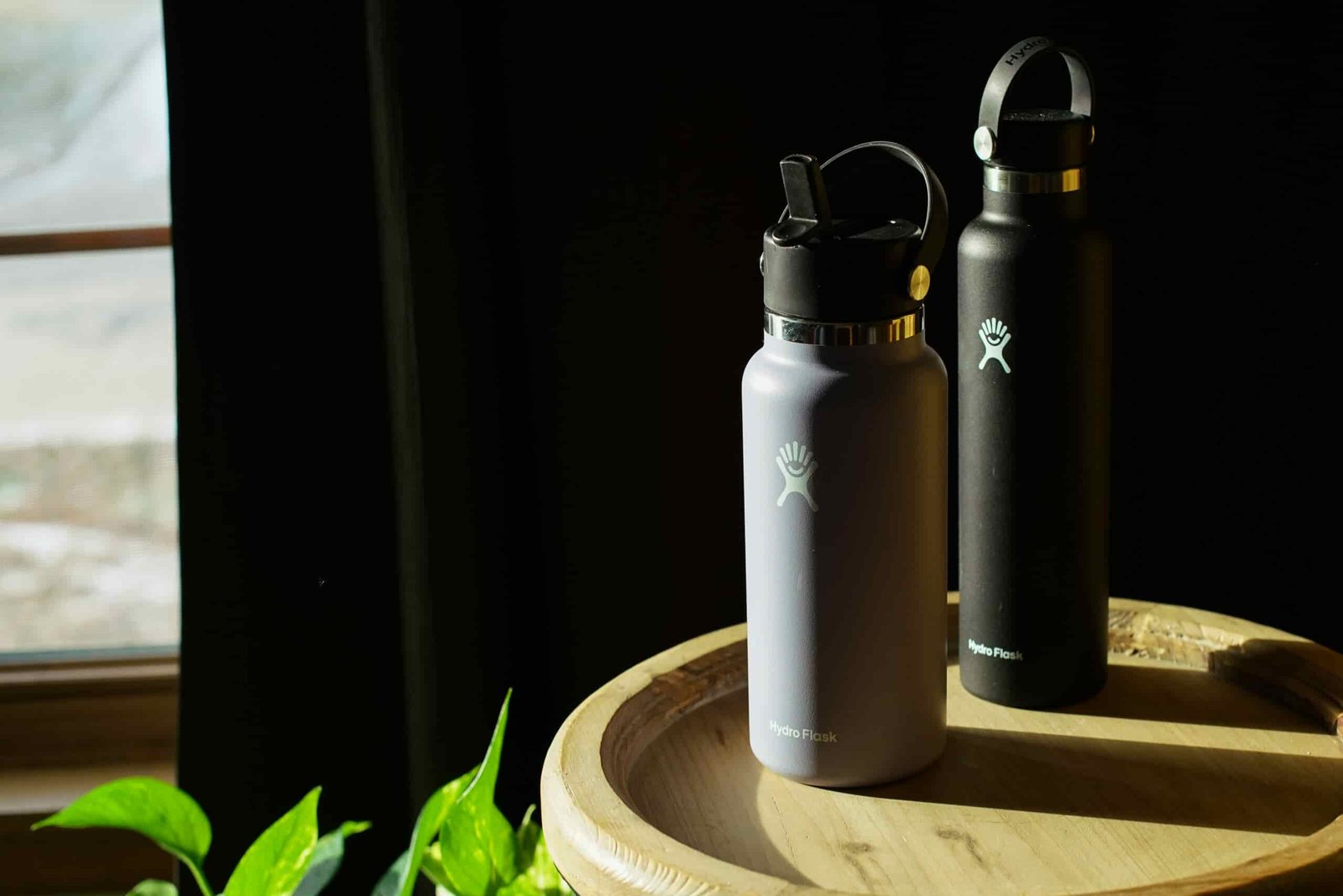 The Hydro Flask Wide Mouth and Hydro Flask Standard Mouth sit next to each other on a table.