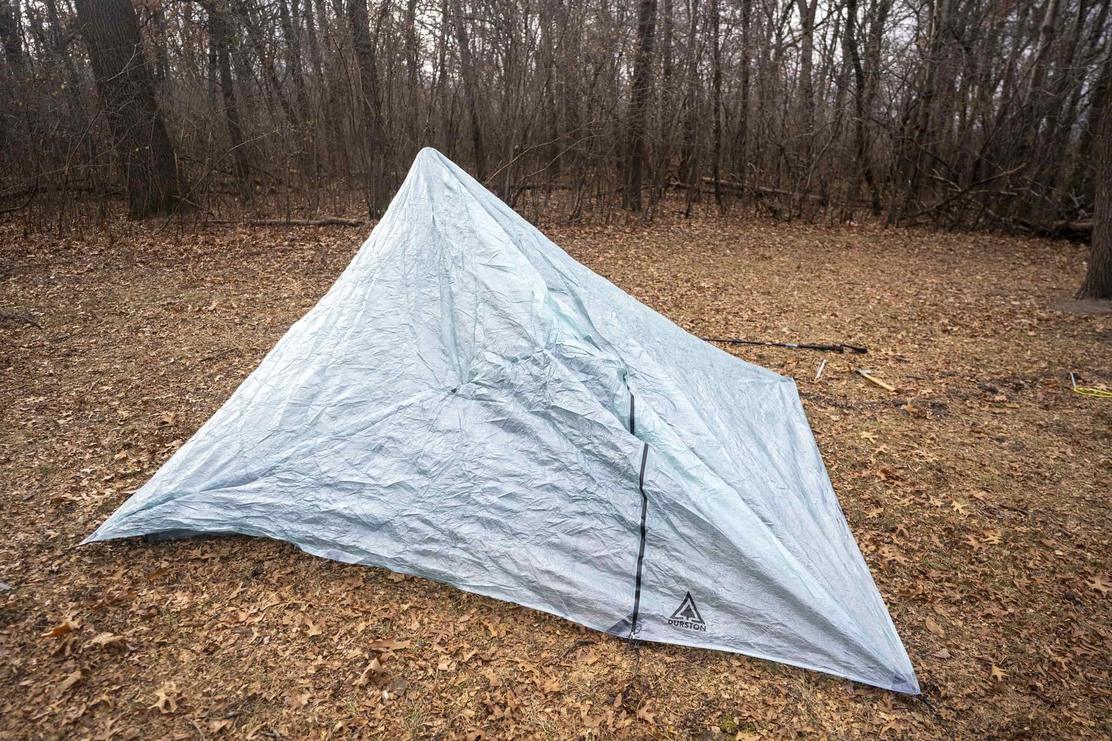 a partially set up trekking pole tent