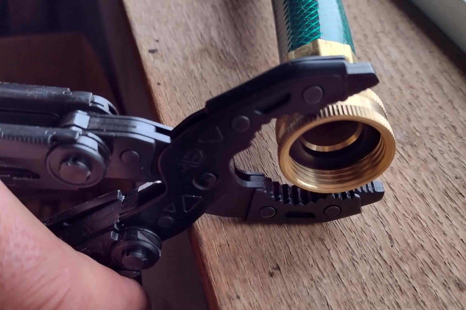 The Gerber Dual-Force pliers gripping a female hose fixture.