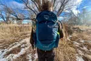 Close up of a person wearing a backpack.