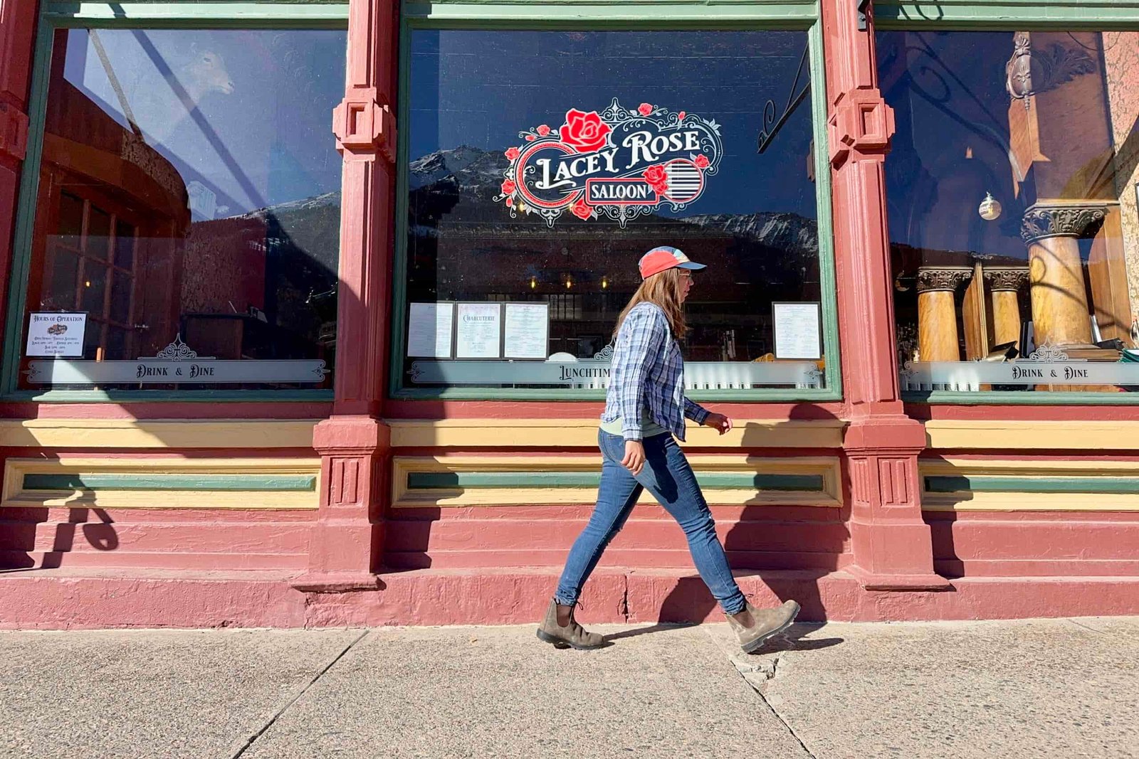 A person wearing the Blundstone Thermal Chelsea boots is walking in front of a historic mountain saloon.