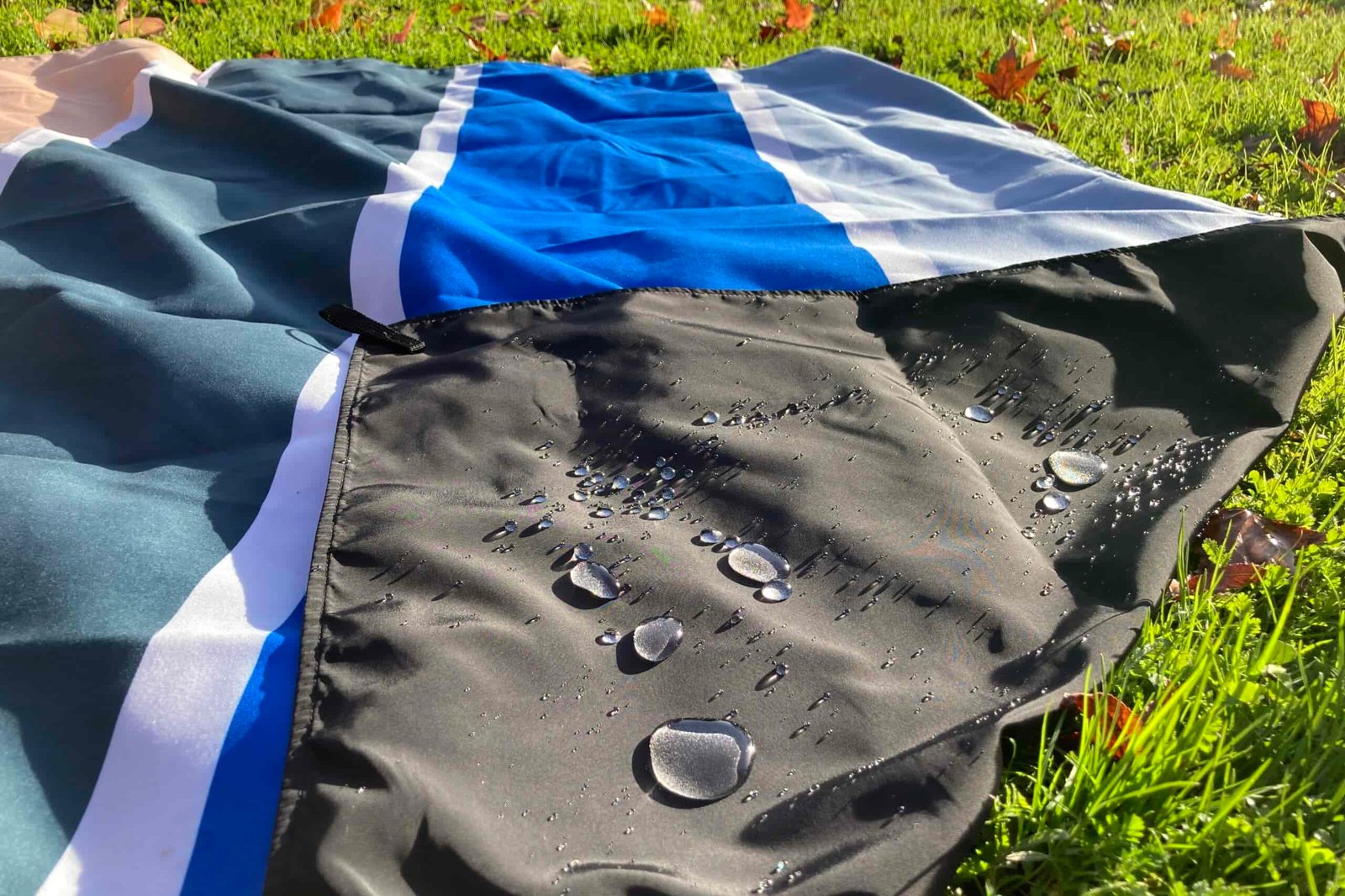 Close up showing water beading on the bottom layer of the Nomadix Festival Blanket