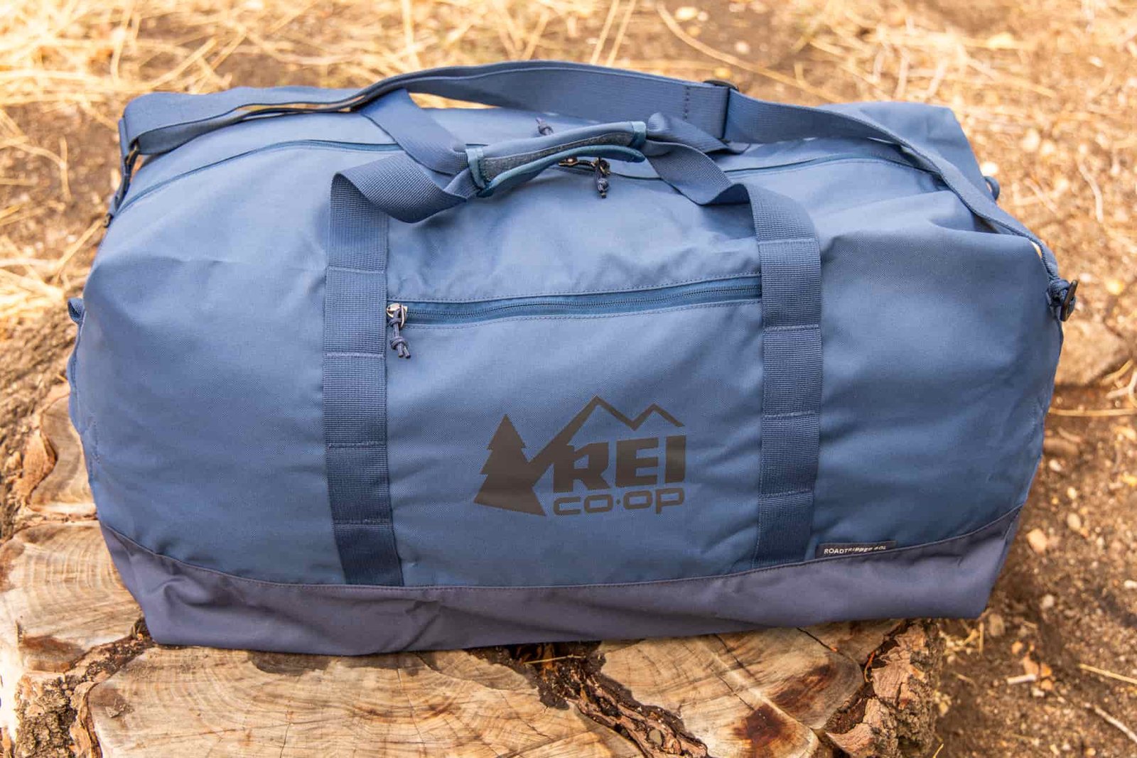The Exterior of the Roadtripper duffel with shoulder strap attached and showing the exterior zipper pocket.