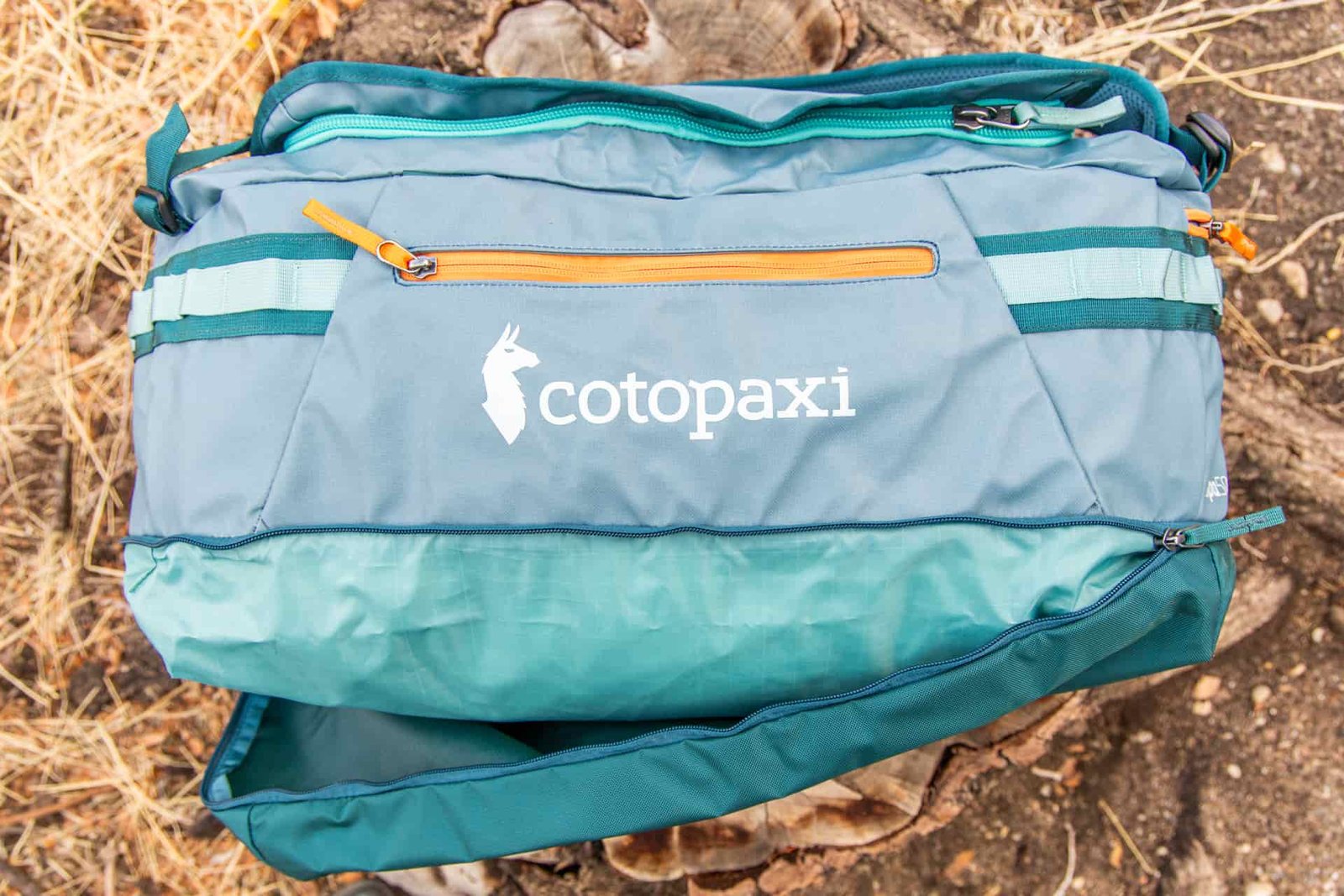 The bottom zipper compartment half open on the Cotopaxi Allpa 50L.